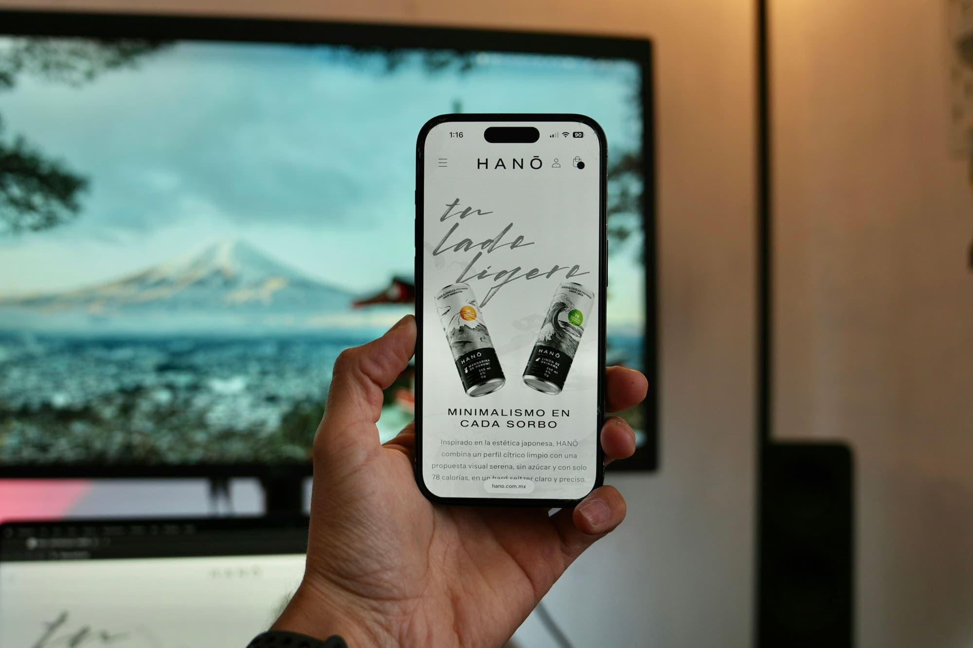 Hand holding a smartphone showing a live website