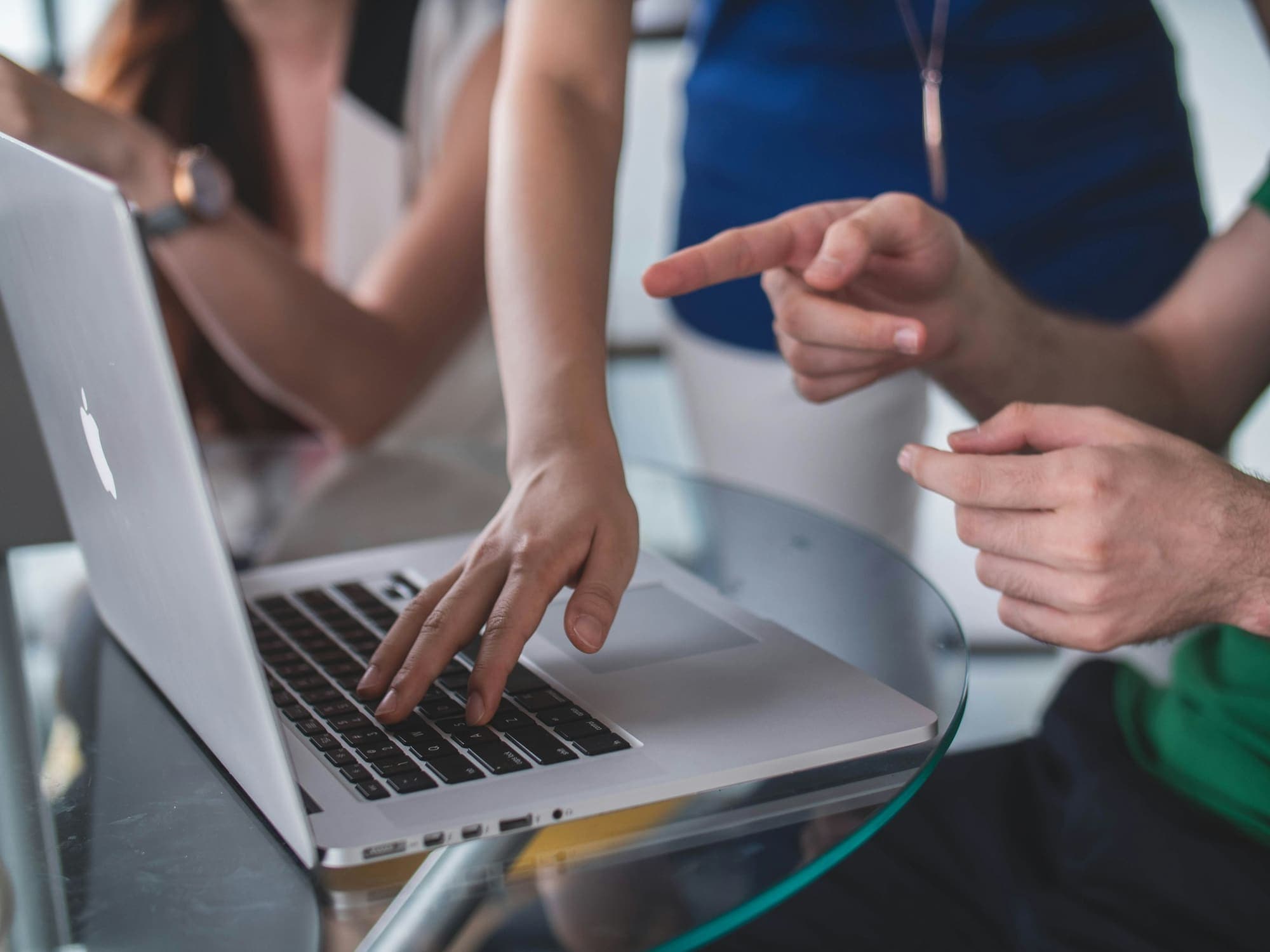 Two people pointing at a laptop while planning a website